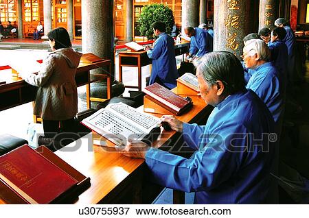 Monks praying with Buddhist scripture View Large Photo Image Stock Photo - Monks praying with Buddhist scripture. Fotosearch