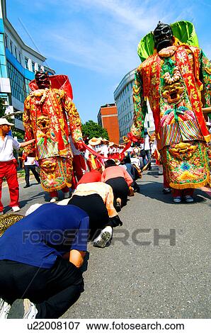 People praying in front of goddess statues during mazu festival, China View Large Photo Image Stock Photo - People praying in front of goddess statues during mazu festival, China. Fotosearch