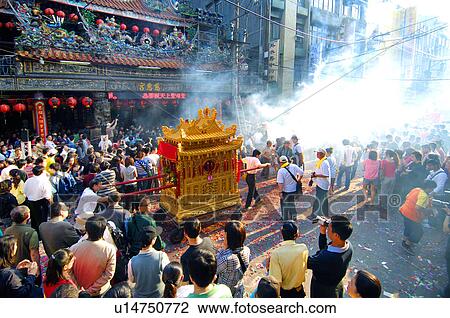 Stock Image - People pulling a pagoda during mazu festival, China. Fotosearch