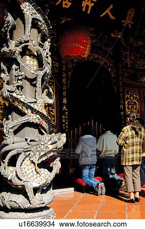 Three people praying in a temple View Large Photo Image Picture - Three people praying in a temple. Fotosearch