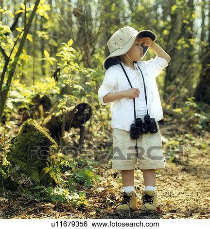 Boy overlooks in the forest View Large Photo Image Stock Photograph - Boy overlooks in the forest. Fotosearch