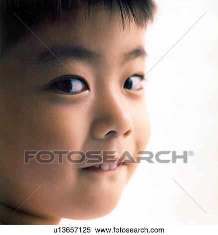 Close-up of a boy smiling View Large Photo Image Stock Photography - Close-up of a boy smiling. Fotosearch