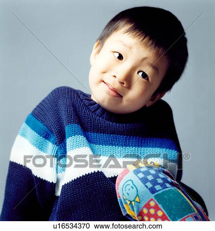 Stock Image - Close-up of a boy thinking. Fotosearch