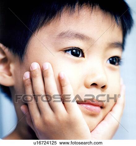 Close-up of a boy thinking with his head in hands View Large Photo Image Stock Photography - Close-up of a boy thinking with his head in hands. Fotosearch