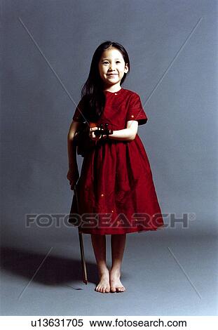 Girl holding a violin View Large Photo Image Stock Photography - Girl holding a violin. Fotosearch