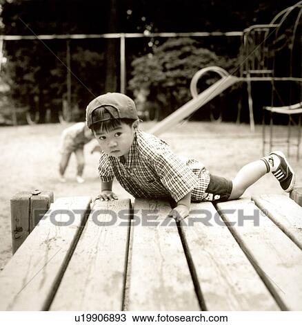 Portrait of a boy fallen on wooden planks View Large Photo Image Stock Image - Portrait of a boy fallen on wooden planks. Fotosearch