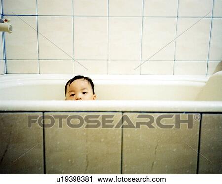 Stock Image - Portrait of a boy in a bathtub. Fotosearch