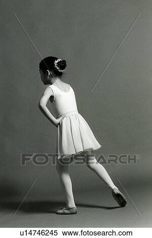Rear view of a girl standing with her hand on her hip View Large Photo Image Stock Photography - Rear view of a girl standing with her hand on her hip. Fotosearch
