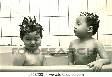 Stock Image - Two brothers having bath in a bathtub. Fotosearch