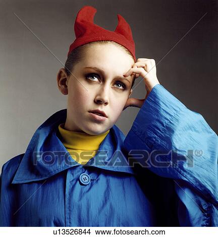 Picture - Woman in devil costume thinking. Fotosearch