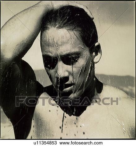 Stock Image - Close-up of a young man bathing. Fotosearch