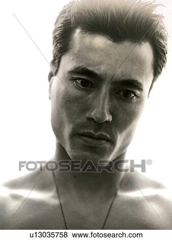 Stock Photo - Close-up of a young man looking down. Fotosearch