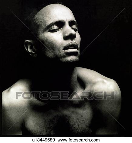 Close-up of a young man with his eyes closed View Large Photo Image Stock Photo - Close-up of a young man with his eyes closed. Fotosearch