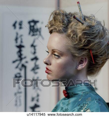 Stock Photography - Close-up of a young woman thinking. Fotosearch