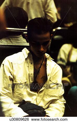 Stock Photograph - Young man looking down. Fotosearch