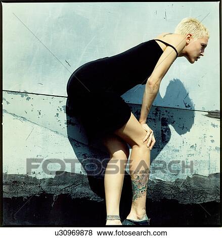 Stock Photo - Male fashion model sitting on the ramp. Fotosearch