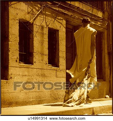 Young man holding a bag and crossing the road View Large Photo Image Picture - Young man holding a bag and crossing the road. Fotosearch