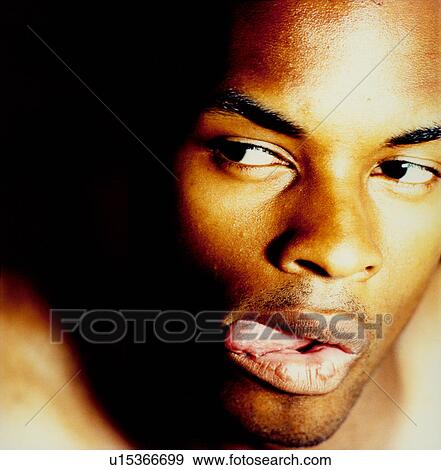 Close-up of a man licking his lips View Large Photo Image Stock Photo - Close-up of a man licking his lips. Fotosearch