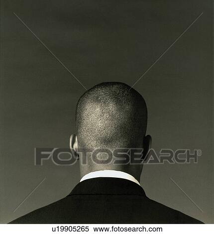 Low angle view of a young man meditating on a rock View Large Photo Image Stock Photography - Low angle view of a young man meditating on a rock. Fotosearch