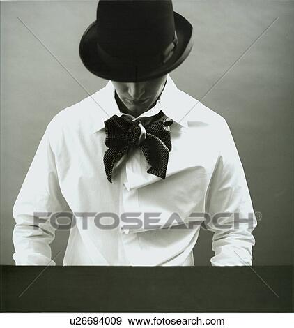 Stock Photo - Man sitting at a table drinking tea. Fotosearch