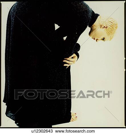 Stock Image - Side profile of a woman bending forward. Fotosearch