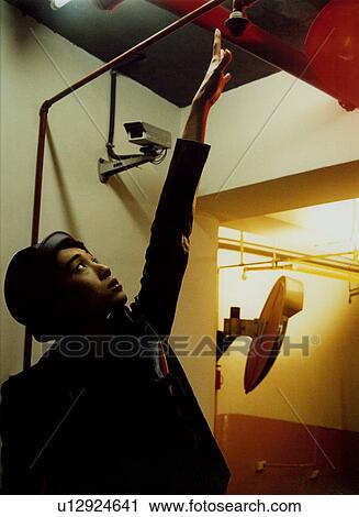 Stock Image - Woman wearing an eye mask. Fotosearch