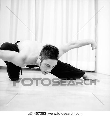 Male dancer practicing in a studio View Large Photo Image Stock Image - Male dancer practicing in a studio. Fotosearch