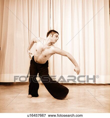 Male dancer practicing in a studio View Large Photo Image Stock Photo - Male dancer practicing in a studio. Fotosearch