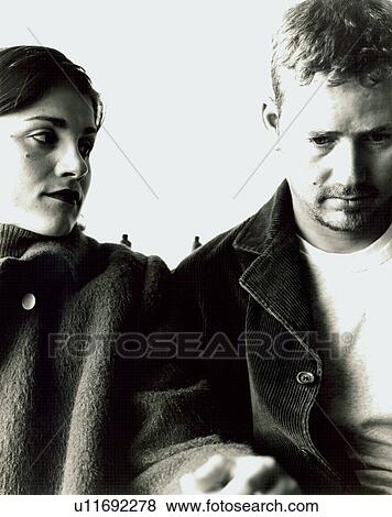 Stock Photo - Close-up of a mid adult couple holding hands of each other. Fotosearch