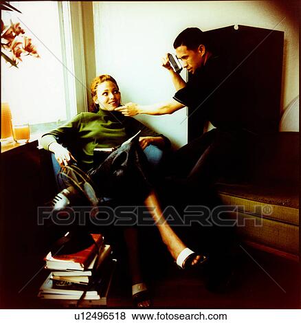 Stock Photo - Young man photographing of a young woman. Fotosearch