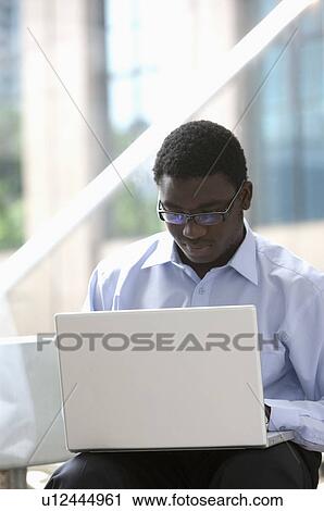 Business people sitting and working with laptop View Large Photo Image Stock Image - Business people sitting and working with laptop. Fotosearch