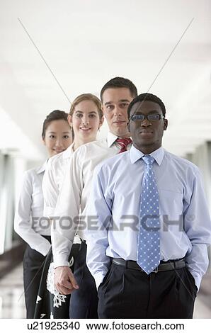 Stock Image - Business people standing in a row and looking at the camera. Fotosearch