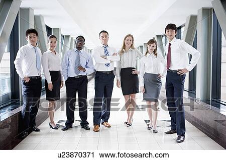 Business people standing in a row and posing together View Large Photo Image Stock Image - Business people standing in a row and posing together. Fotosearch