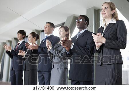 Business people standing in a row and clapping together View Large Photo Image Stock Photograph - Business people standing in a row and clapping together. Fotosearch