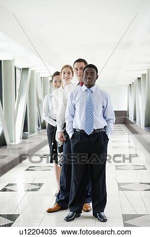 Stock Photography - Business people standing in a row and looking at the camera together. Fotosearch