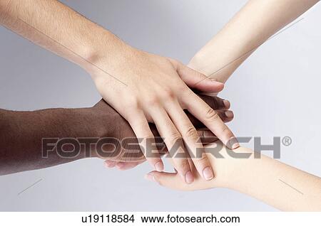Close-up of different colors of hands huddling together View Large Photo Image Picture - Close-up of different colors of hands huddling together. Fotosearch