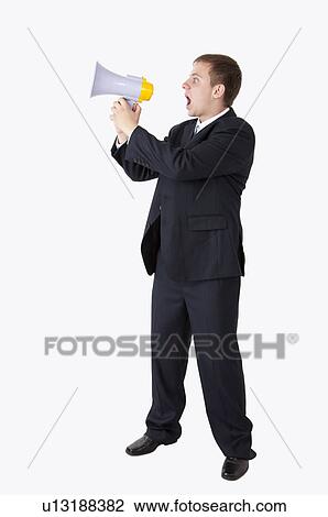 Businessman standing and shouting with a megaphone View Large Photo Image Stock Image - Businessman standing and shouting with a megaphone. Fotosearch