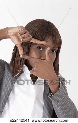 Stock Image - Close-up of businesswoman making finger frame. Fotosearch