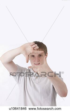 Close-up of young man making finger frame View Large Photo Image Stock Photograph - Close-up of young man making finger frame. Fotosearch