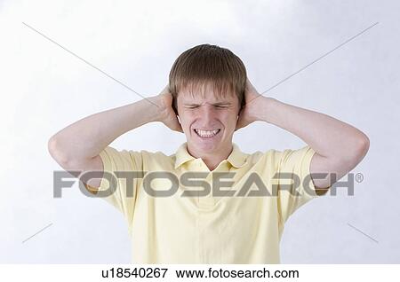 Young man frowning with eyes closed and head in hands View Large Photo Image Stock Photo - Young man frowning with eyes closed and head in hands. Fotosearch
