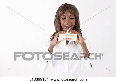Young woman holding a sandwich with mouth open View Large Photo Image Picture - Young woman holding a sandwich with mouth open. Fotosearch