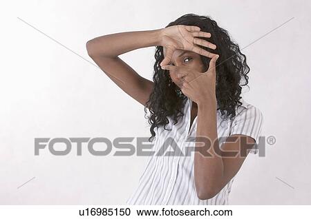 Young woman making finger frame and looking at the camera View Large Photo Image Stock Image - Young woman making finger frame and looking at the camera. Fotosearch