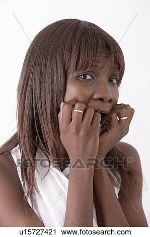 Young woman shocked with fingers on lips and looking at the camera View Large Photo Image Stock Image - Young woman shocked with fingers on lips and looking at the camera. Fotosearch