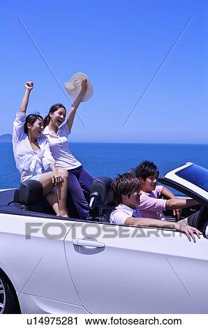 Four people driving in the car and enjoying leisure activity together View Large Photo Image Stock Image - Four people driving in the car and enjoying leisure activity together. Fotosearch