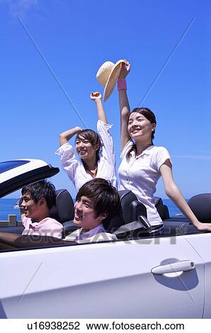 Four people driving in the car and enjoying leisure activity together View Large Photo Image Stock Image - Four people driving in the car and enjoying leisure activity together. Fotosearch