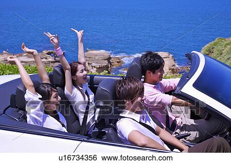 Four people enjoying leisure activity and sitting in the car with smile View Large Photo Image Stock Photograph - Four people enjoying leisure activity and sitting in the car with smile. Fotosearch