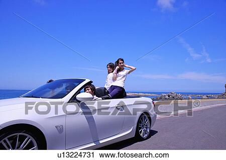 Four people relaxing on the road trip and smiling happily View Large Photo Image Stock Image - Four people relaxing on the road trip and smiling happily. Fotosearch
