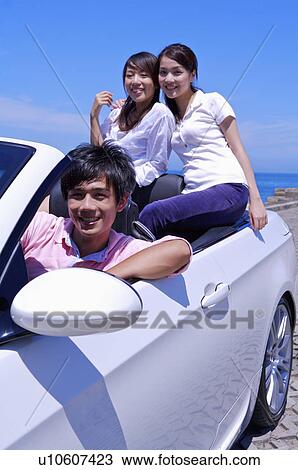 Three people driving in the car and enjoying leisure activity together View Large Photo Image Stock Image - Three people driving in the car and enjoying leisure activity together. Fotosearch