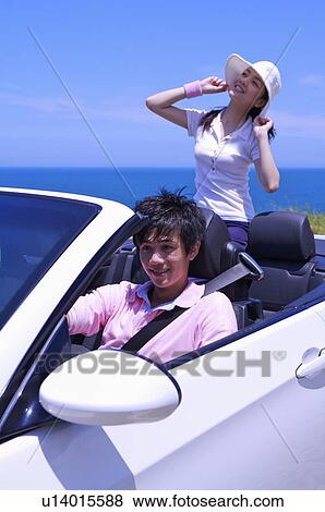 Young couple driving in the car and enjoying leisure activity together View Large Photo Image Stock Photo - Young couple driving in the car and enjoying leisure activity together. Fotosearch