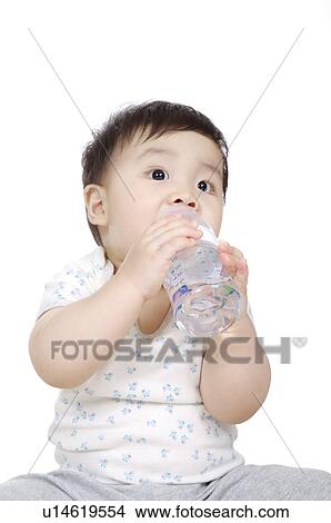 Baby boy drinking water and looking away View Large Photo Image Picture - Baby boy drinking water and looking away. Fotosearch